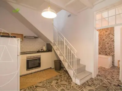 a staircase in a kitchen with a stair case at Old Charming Faro Apartment in Faro
