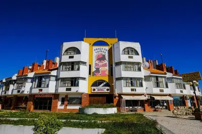 a large white and yellow building with a sign on it at AL-Dream Oura Estrela Apartments - CD in Albufeira