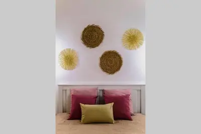 a room with pink and yellow pillows and a white wall at AL-Dream Oura Estrela Apartments - CD in Albufeira