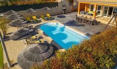 an overhead view of a swimming pool with umbrellas and chairs at Villa Florida by Algarve Vacation in Albufeira