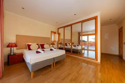 a bedroom with two beds and a large window at Villa Florida by Algarve Vacation in Albufeira
