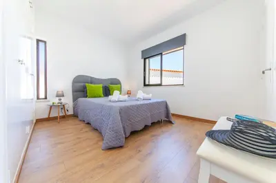 a bedroom with a bed and a table with green pillows at Villa Abel by Algarve Vacation in Albufeira
