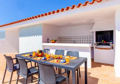 a dining room with a blue table and chairs at Villa Abel by Algarve Vacation in Albufeira