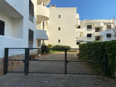 a black gate in front of a building at Casa de Vilamoura in Vilamoura