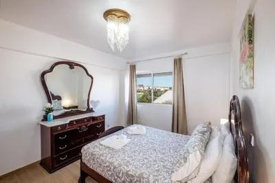 a bedroom with a bed with two towels on it at #012 Exclusivo para Famílias, Habijovem by Home Holidays in Albufeira