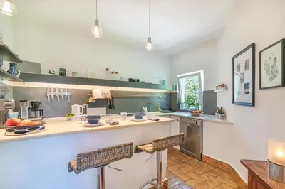 a large kitchen with a counter and a counter top at Casa felix in Loulé