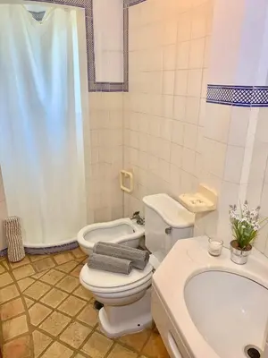 a bathroom with a toilet and a sink and a tub at Villa Amendoeiras 52 in Albufeira