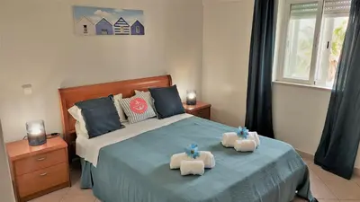 a bedroom with a bed with two towels on it at 3 bedroom apartment in Oura Albufeira with amazing pool at walking distance to beach, strip and old town, WIFI and AC, private condo in Albufeira