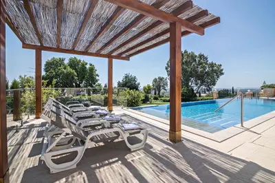 a patio with lounge chairs and a swimming pool at Cabana Gardenhouse in Loulé