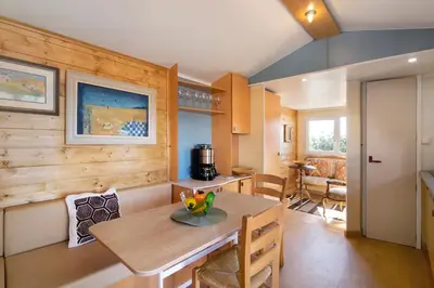 a kitchen and dining room with a table and chairs at Cabana Gardenhouse in Loulé
