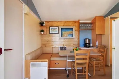 a small kitchen with a table and chairs at Cabana Gardenhouse in Loulé