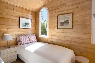 a bedroom with a white bed and a window at Cabana Gardenhouse in Loulé