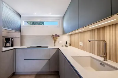 a kitchen with a sink and a window at Apartment Dansk in Almancil
