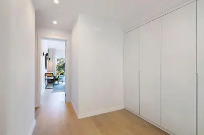 an empty hallway with white walls and wood floors at Apartment Dansk in Almancil
