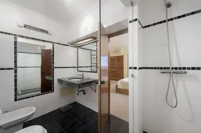 a bathroom with a shower and a toilet and a sink at LovelyStay - Bela Vista 3BDR Duplex Penthouse with Pool in Albufeira