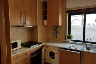 a small kitchen with a sink and a microwave at Aparto Golf in Guia