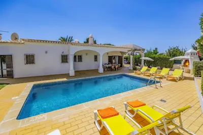 a villa with a swimming pool and a house at Villa Aldeia by Villa Plus in Albufeira