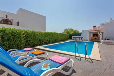 a swimming pool with lounge chairs and a swimming pool at Villa Altis by Villa Plus in Albufeira