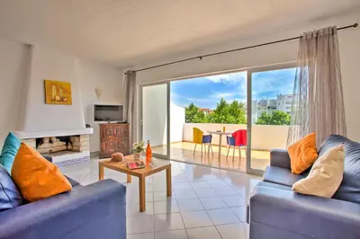 a living room with two blue couches and a table at Villa Altis Park by Villa Plus in Albufeira