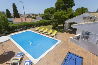 a swimming pool in the backyard of a house at Villa Elo by Villa Plus in Albufeira