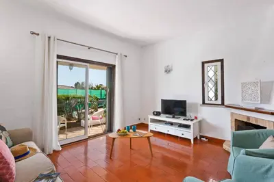 a living room with a couch and a table and a television at Villa Emilio Pequena by Villa Plus in Albufeira