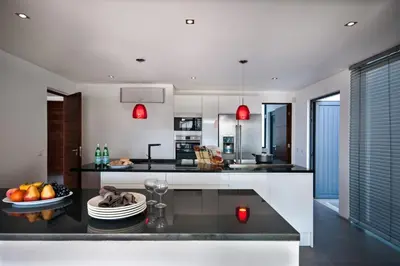 a kitchen with a table with a bowl of fruit on it at Villa Eve by Villa Plus in Olhos de Água