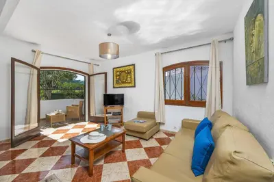 a living room with a couch and a table at Villa Montechoro by Villa Plus in Albufeira