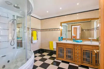a bathroom with two sinks and a shower at Villa Soni by Villa Plus in Olhos de Água