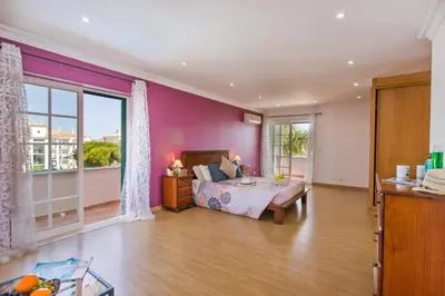 a bedroom with a bed and a large window at Villa Soni by Villa Plus in Olhos de Água