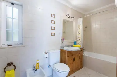 a bedroom with a bed and a door to a balcony at Villa Teotel by Villa Plus in Almancil