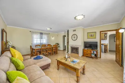 a living room with a couch and a fireplace at Villa Teotel by Villa Plus in Almancil