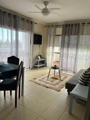 a living room with a table and a dining room at House Amendoeiras , Vila moura in Vilamoura