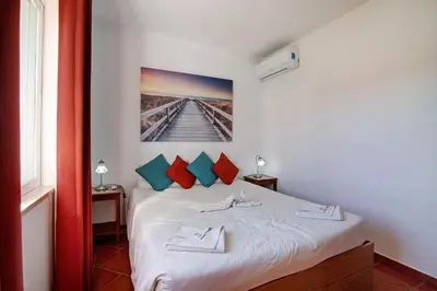 a bedroom with a bed with two towels on it at Villa Isabel in Loulé