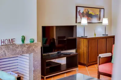 a living room with a fireplace and a tv at AL - Apartamento Vila Sol F5 AA in Vilamoura