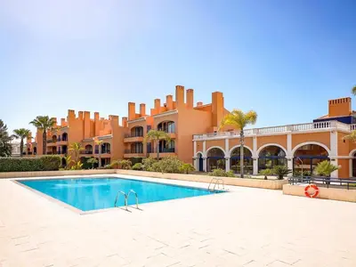 a resort swimming pool in front of a building at AL - Apartamento Vila Sol F5 AD in Vilamoura