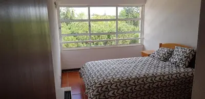 a bedroom with a bed and a large window at New Grand duplex avec terrasse plein sud vue piscine in Vilamoura