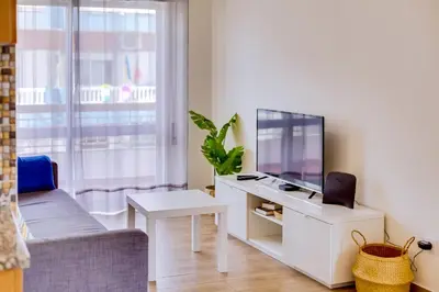 a living room with a tv and a couch at Quarteira 2Br - near the beach at Homesbyfc in Quarteira