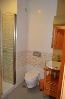 a bathroom with a toilet and a sink at Apartamento frente ao mar com piscina de água salgada in Quarteira