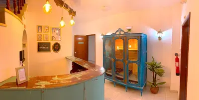 a shop with a blue cabinet in a room at The Central Guesthouse in Faro