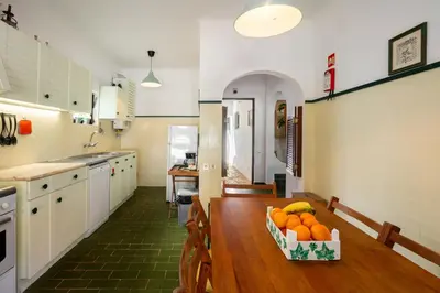 a kitchen with a table with a bowl of fruit on it at WHome | Balaia 3-Bed Family Holiday Villa in Olhos de Água