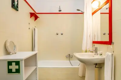 a bathroom with a sink and a toilet and a tub at WHome | Balaia 3-Bed Family Holiday Villa in Olhos de Água