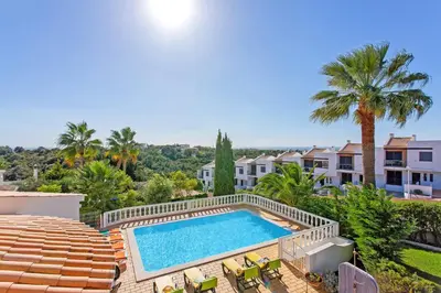 a room with a bed and a balcony at Villa Ninho da Aguia by Villa Plus in Albufeira