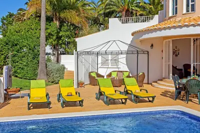 a living room with a couch and stairs at Villa Ninho da Aguia by Villa Plus in Albufeira