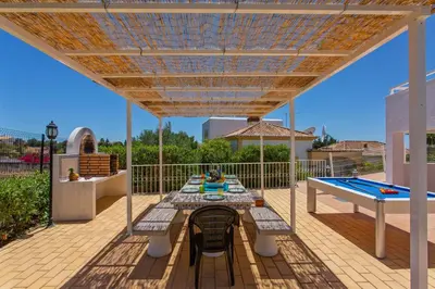 a kitchen and dining room with a table and chairs at Villa Ninho da Aguia by Villa Plus in Albufeira