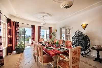 a dining room with a table and chairs at Villa Nenufa by Villa Plus in Albufeira