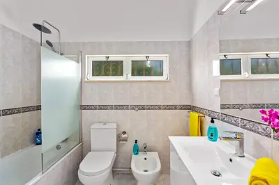 a bathroom with a white toilet and a sink at Villa Animado by Villa Plus in Albufeira