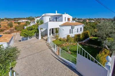 an aerial view of a white house with a fence at Villa Casa do Laguinho by Villa Plus in Albufeira