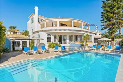 a villa with a swimming pool in front of a house at Villa Aldeia Cristina by Villa Plus in Albufeira