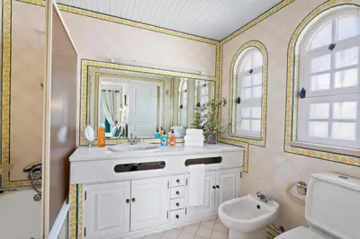 a bathroom with a sink and a toilet and a mirror at Villa Aldeia Cristina by Villa Plus in Albufeira