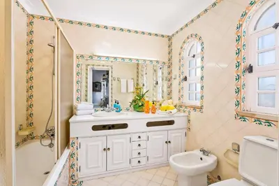 a bathroom with a sink and a shower and a toilet at Villa Aldeia Cristina by Villa Plus in Albufeira